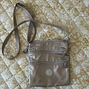 Kipling Tan Crossbody Bag with Adjustable Strap and Versatile Design